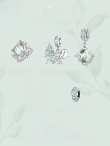 Detail view of S925 silver mint green charms including butterfly and heart pendants