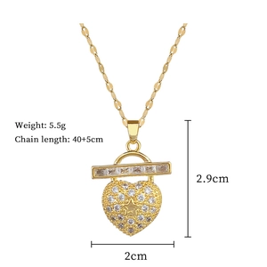Macro shot of gold heart and lock pendant with full crystal pavé detailing and specs