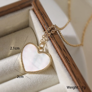 Detail shot of 18K gold heart pendant with dimensions and weight on velvet display