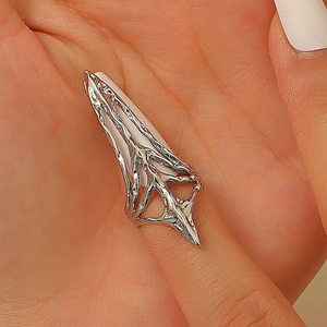 Close-up of gothic silver claw nail ring with split branch vine design on finger