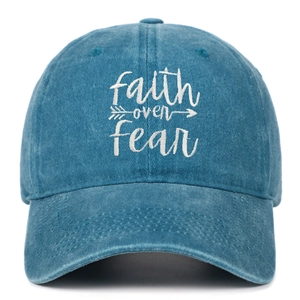Detail of Faith Over Fear embroidery on blue washed cotton baseball cap with curved brim