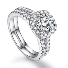 Close-up of S925 silver halo ring set with round white zircon and pavé detailing