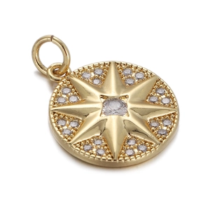 Macro detail of gold north star pendant with sparkling cubic zirconia on white background