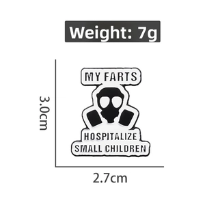 Detail showing dimensions and weight of the gas mask enamel pin in black and white