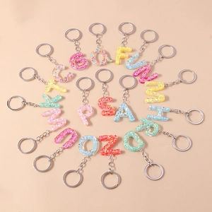 Alphabet keychains set with resin glitter letters A-Z arranged in a spiral layout