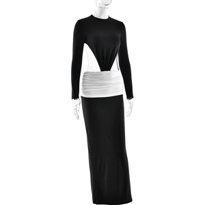 Detail of waist cut-out design and pleated white contrast on black long sleeve maxi dress