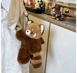 Detailed view of the red panda plush crossbody bag with adjustable beige strap