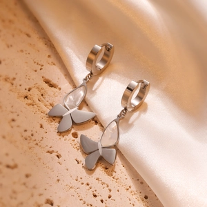 Minimalist gold-plated butterfly drop earrings with shell inlays on silk background
