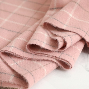 Close-up of soft pink plaid cashmere-like fabric showing detailed woven texture and pattern
