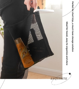 Close-up of portable black mesh cosmetic bag featuring durable zipper and wrist strap