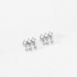 Detail of silver S925 earrings featuring three rows of sparkling zircon tassel pendants