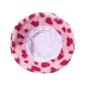 Close-up of pink spotted plush bucket hat showing thick faux fur texture and inner lining