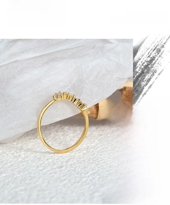 Macro detail of 18k gold plated ring featuring a delicate curved zircon stone setting