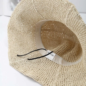 Close-up of handmade straw hat interior with sweatband and adjustable drawstring feature