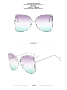 Close-up of square butterfly sunglasses with silver metal frame and pearl temple details