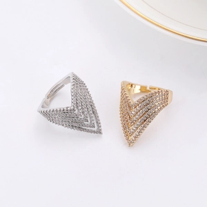Macro shot of V-shaped open rings with pavé cubic zirconia in gold and silver finish