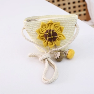 Detailed view of kids cream straw bag featuring a yellow sunflower and zip closure