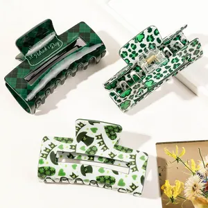 Three St. Patrick's Day hair claws featuring clover patterns and green festive designs