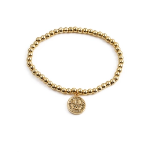 Golden beaded bracelet featuring a sparkling zircon smiley face charm on a white background