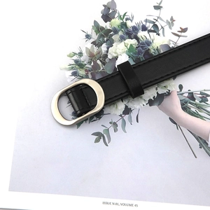 Minimalist black faux leather belt for women featuring a polished gold oval buckle