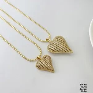 Detail view of gold striped heart pendant necklaces with weights 10.4g and 16.7g
