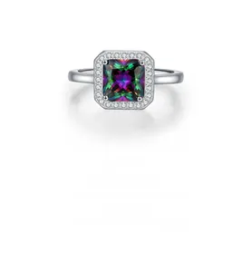 Macro shot of silver ring featuring a square rainbow gemstone with diamond halo detail
