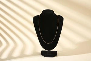 Detailed view of a fine gold-plated DIY craft chain necklace on a black velvet display