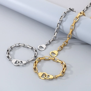Detail of geometric link necklaces and bracelets with handcuff clasps in gold and silver