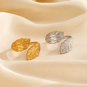 Minimalist stainless steel leaf rings in gold and silver finish with adjustable open band
