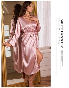 Detail of pink satin robe with silk texture, featuring a V-neck and elegant waist tie
