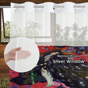 Detail of sheer window curtain with metal grommets and colorful artistic portrait pattern