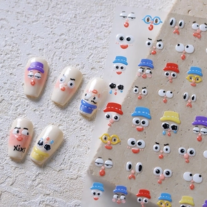 3D embossed cartoon emoji nail stickers with cute face patterns on almond nails
