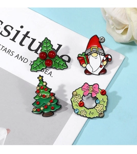 Detail of colorful enamel Christmas brooches with rhinestones on a blue background