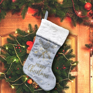 Silver-grey suede Christmas stocking with white plush trim and golden Merry Christmas text