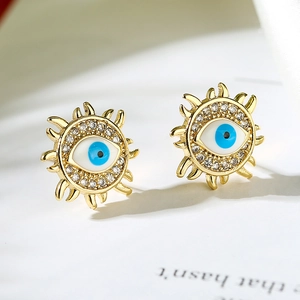 Close-up of 18K gold plated evil eye stud earrings with blue enamel and zircon stones