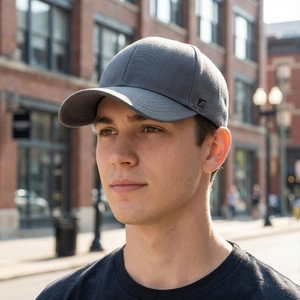 Outdoor lifestyle view of a dark gray cotton baseball cap for men with side metal badge