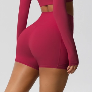 Detail view of high-waist yoga shorts in burgundy with V-shaped stitching for a lifting effect