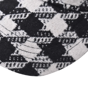 Macro view of thick houndstooth pattern fabric and neat stitching on baseball cap brim