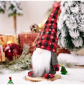 Detailed view of Christmas gnome with red plaid snowflake hat on a festive wooden base