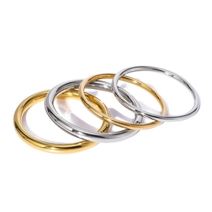 Set of four minimalist hollow stainless steel bangles in polished gold and silver finishes