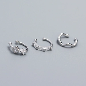 Detailed macro view of S925 sterling silver ear cuffs with cubic zirconia inlay details