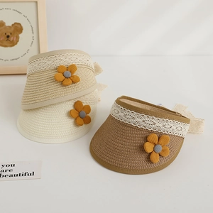 Detailed close-up of straw sun visors with delicate lace edges and floral accents