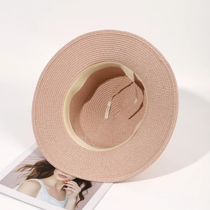 Close-up of pink straw sun hat showing woven texture and adjustable inner headband