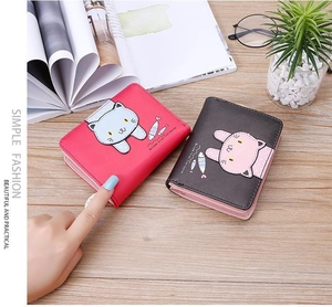 Detail of PU leather short wallet featuring cute cartoon cat print and secure buckle