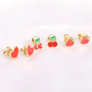 Detail view of 3 pairs of fruit earrings featuring red cherry, strawberry and heart designs