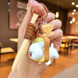 Cute cartoon puppy wearing a toast frame keychain held in hand at a warm cafe
