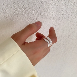 Detailed view of an irregular textured S925 sterling silver ring worn on a finger