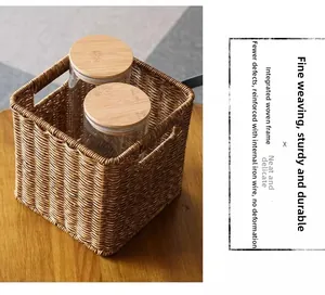 Detail view of woven storage basket with iron frame reinforcement and side handles