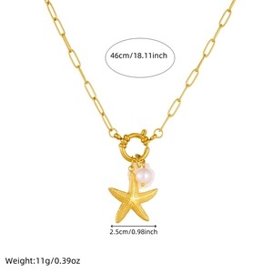 Gold ocean necklace with starfish, pearl, and shell charms on a paperclip chain