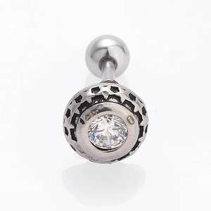 Detailed close-up of a silver earring with star cutout patterns and a clear cubic zirconia